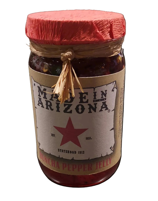 Jar of salsa with a star label on a gray surface