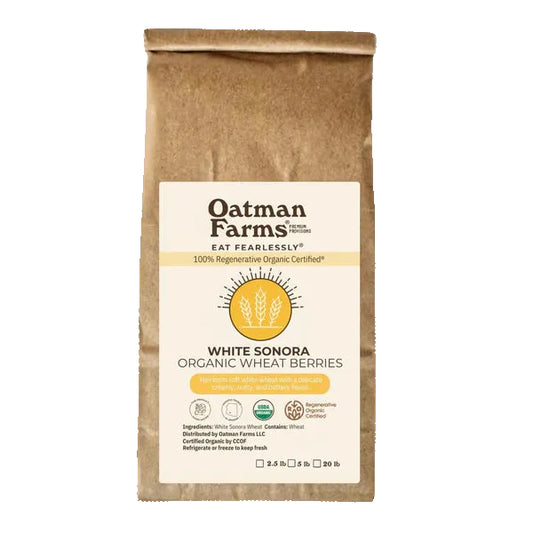 Bag of Oatman Farms White Sonora Organic Wheat Berries with a scenic background